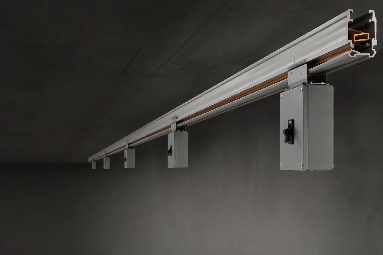 Overhead track busway runs above AI data center racks with tap-off boxes